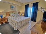 King bed in master suite with full bath, flat panel tv